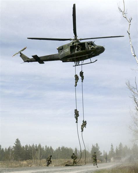 Assaulters from Joint Task Force 2 are seen fast roping from a Griffon helicopter during an ...