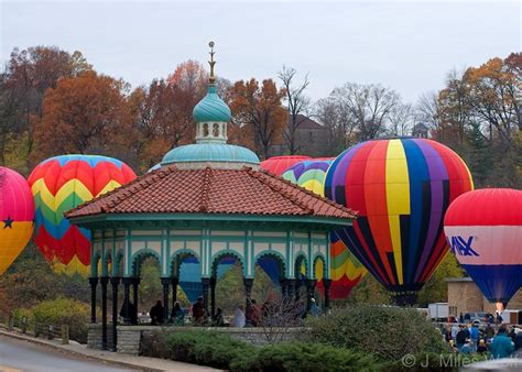 colorful hot air balloons are in the sky above a gazebo and pavilion at ...