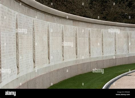 Names of fallen WWII soldiers carved in a long wall at the American cemetery, Normandy Stock ...