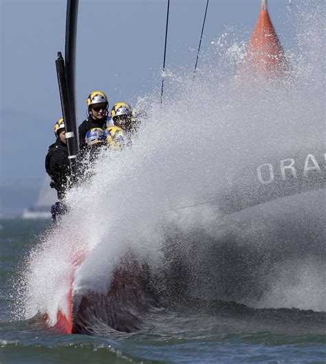 Oracle Team USA hits a wave during the 18th race of the America's Cup ...