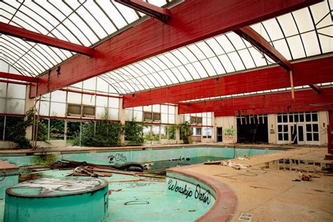 an abandoned swimming pool with graffiti on the walls and floor, in ...