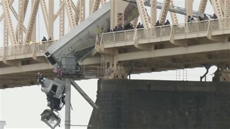 Truck Driver Pulled to Safety After Crash Leaves Vehicle Dangling Over Bridge Across Ohio River ...