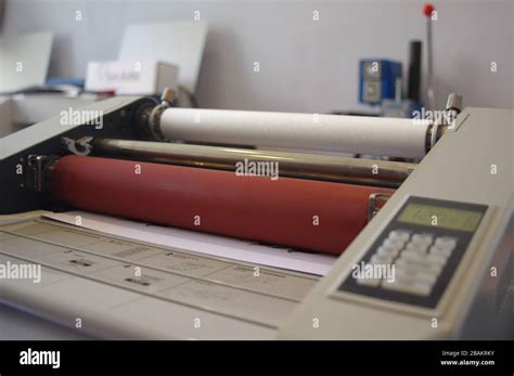 Plastic laminating machine Stock Photo - Alamy