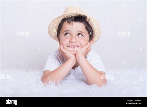 Funny child. Little boy thinking lying on bed Stock Photo - Alamy