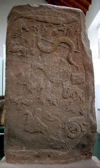 a large stone with carvings on it in a museum