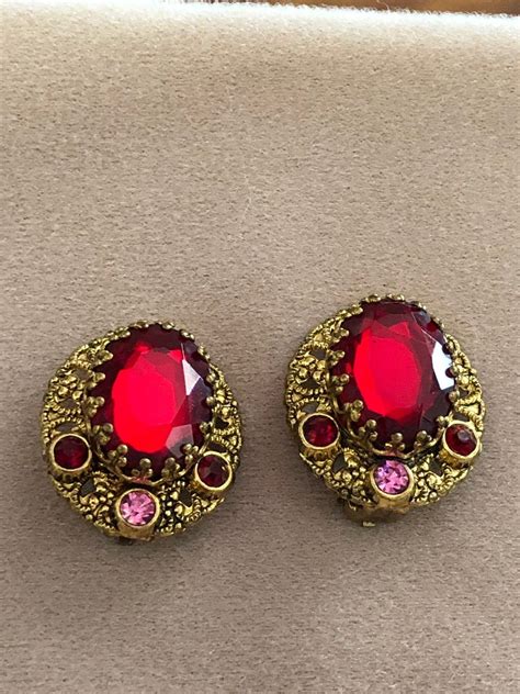 Vintage W Germany Ruby Red Earrings on Mercari | Red earrings, Red rhinestone earrings, Red ...