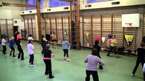 a group of people standing around in a gym