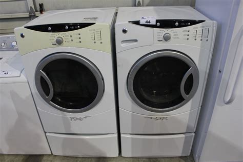 GE FRONT LOAD WASHER AND DRYER SET ON PEDESTALS