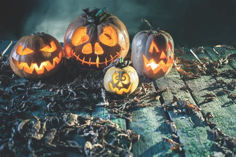 Halloween Pumpkins at Wood Background. Carved Scary Faces of Pumpkin. Stock Photo - Image of ...