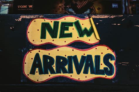 New Arrivals Sign On Wooden Surface · Free Stock Photo