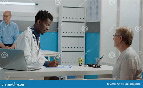 Young Doctor Using Stamp on Prescription Paper on Desk Stock Image ...