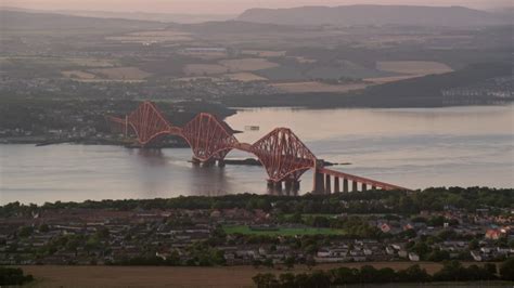 5.5K stock footage aerial video of a commuter train on Forth Bridge over Firth of Forth ...