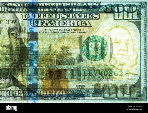 A United States of America 100 dollar bill has been backlit in order for the security watermark ...