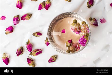 Rose tea in a cup on white fabric Stock Photo - Alamy