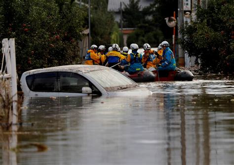 Rescuers search waist-high muddy waters for missing people in typhoon ...