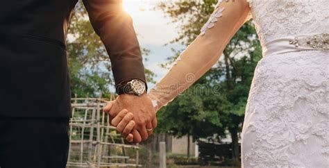 Couple Holding Hands on Their Wedding Day Stock Photo - Image of people, closeup: 112657532