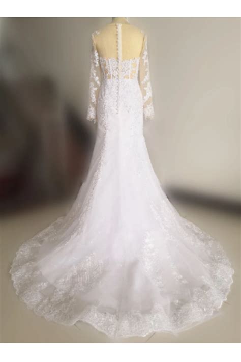 a white wedding dress is displayed on a mannequin headdress with an open back and long sleeves