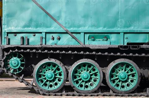 Side view of the vehicle on a caterpillar track with black tracks and ...