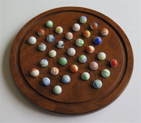 Marble Solitaire Game Hardwood Board with 33 Old Glass swirl Marbles at 1stDibs