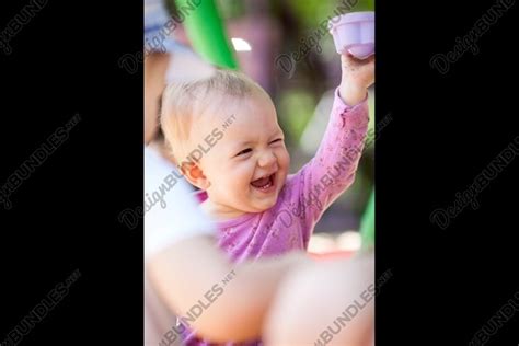 Laughing little baby playing with a toy