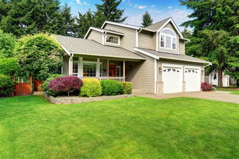 American House Exterior With Double Garage And Well Kept Lawn. - Bill's Siding and Windows