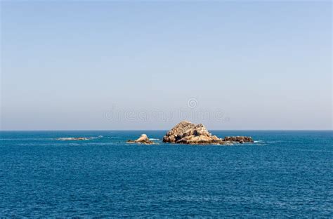 Rock formation in blue sea stock photo. Image of rock - 7312310