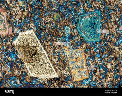 Andelatite mineral rock crystals, polarised light micrograph. This rock's mineral composition is ...