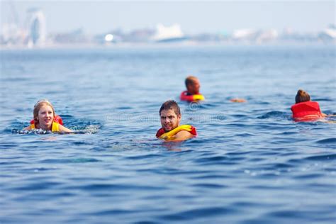 People In Lifejackets Swimming In Open Sea Stock Image - Image of ...