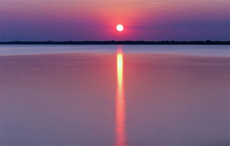 Hazy sunset on the lake with smooth water Photograph by David Ilzhoefer - Fine Art America