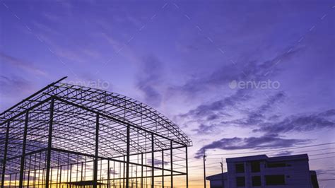 Silhouette metal warehouse structure with office building in ...