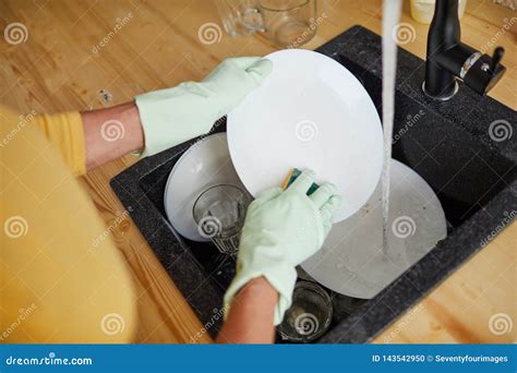 Hand washing dishes stock photo. Image of busy, dish - 143542950