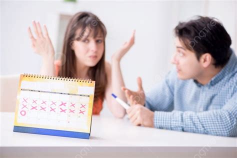 Young Family In Pregnancy Planning Concept With Ovulation Calendar Young Family In Pregnancy ...