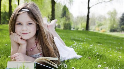 Lovely Little Girl Reading a Book on the Grass - Mystery Wallpaper