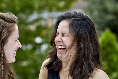 Two Girls Laughing Together Stock Photo | Adobe Stock