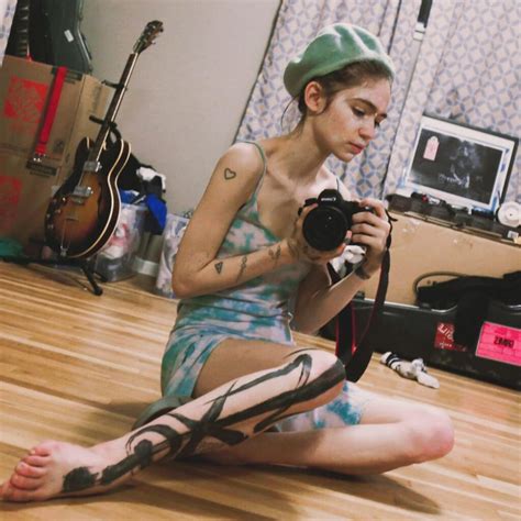 Grimes Debuts New Gnarly White-Ink “Alien Scars” Full Back Tattoo