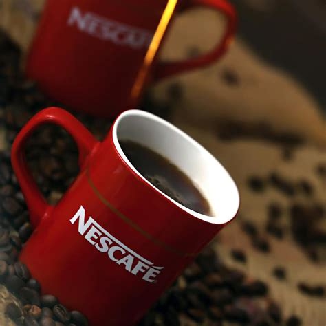 White and Red Nescafe Ceramic Coffee Mug With Coffee · Free Stock Photo