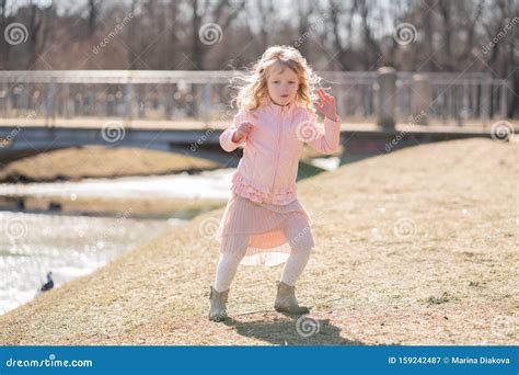 Little Girl Walking Alone in the City Park and Enjoy. Stock Image ...