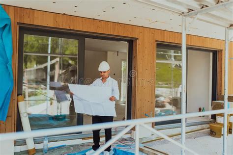 A Architect Looking at Plan and Thinking about Working on Big Project ...