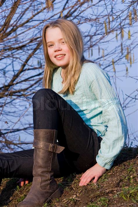 A smiling teenage girl with boots on | Stock image | Colourbox