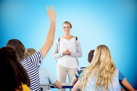 Premium Photo | Student raising hand in classroom against blue ...