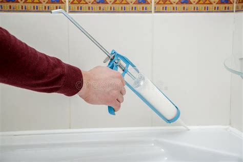 Plumber Hand Applying Silicone Sealant in the Bathroom. Stock Image - Image of hermetic, glue ...