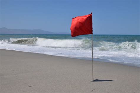 Red flag on beach stock image. Image of surf, sand, yellow - 194923909