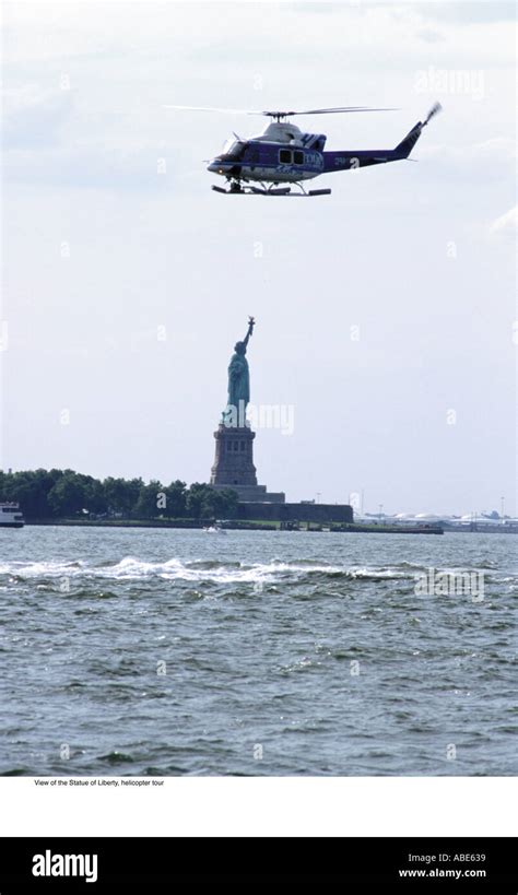 Helicopter flying over the statue of liberty Stock Photo - Alamy