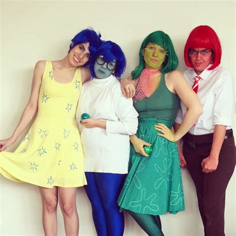 four people dressed up in costumes posing for the camera