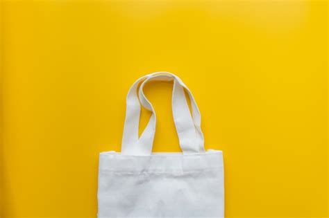 Premium Photo | Flat lay of sustainable products cloth bag on yellow