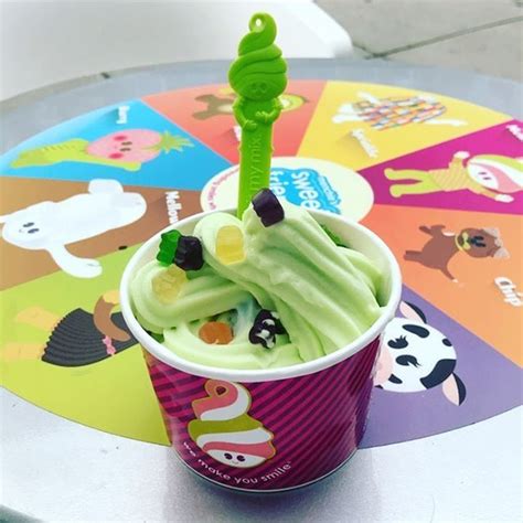 a cup filled with ice cream sitting on top of a table