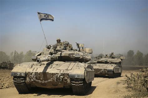 IDF modified Merkava 3 tanks moving to positions. Note additional protection of hull bottom, 3 ...