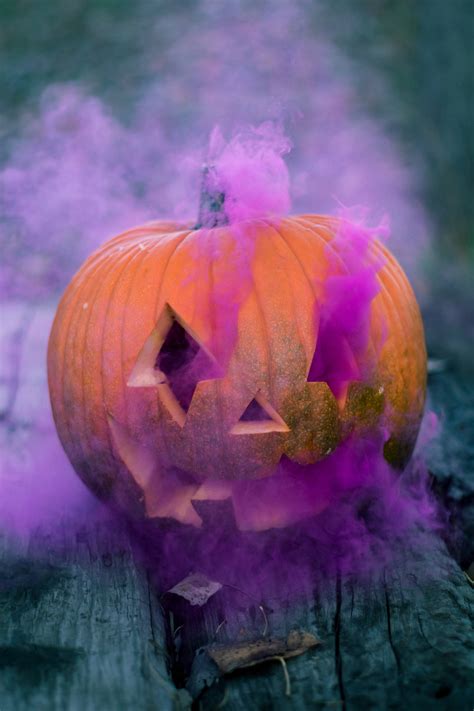 Download Spooky Pumpkin With Purple Smoke Wallpaper | Wallpapers.com