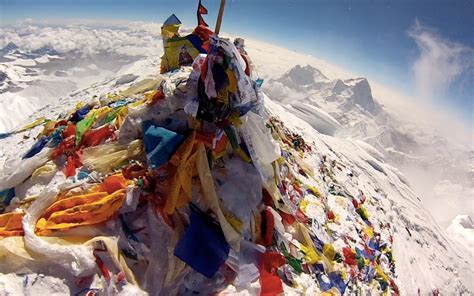 The summit of Mount Everest, littered with flags from climbers. : r/pics