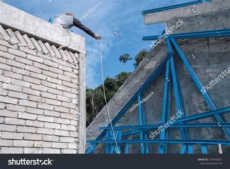 Construction Worker Installing Metal Roof Trusses Stock Photo ...